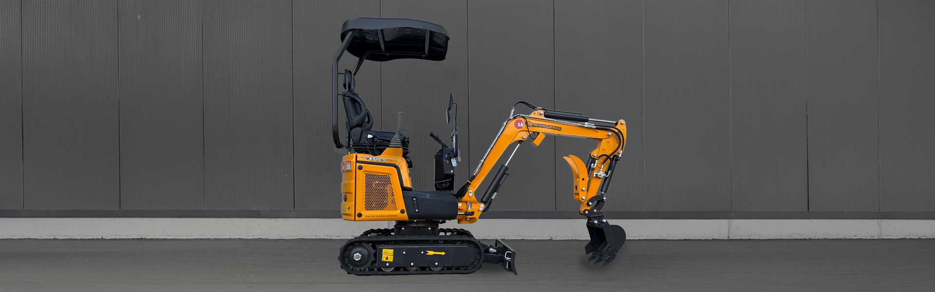 Rhinoceros Minibagger KS10-9 in der Seitenansicht mit Knickarm und Gummiketten